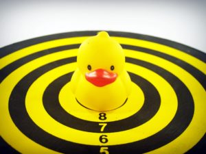 yellow bath duck toy on a target board
